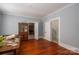 Room with wood floors, antique hutch, and doorway to stairs and kitchen at 1173 Cat Square Rd, Vale, NC 28168