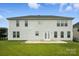 View of back exterior showing a well-maintained lawn, a patio, and the home's siding and windows at 1281 Arges River Dr, Fort Mill, SC 29715
