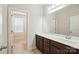 Bathroom featuring dark cabinets, quartz countertops, tile flooring, and a bright, well-lit vanity mirror at 1281 Arges River Dr, Fort Mill, SC 29715
