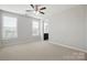 This bedroom features neutral walls, large windows, a ceiling fan, and carpet at 1281 Arges River Dr, Fort Mill, SC 29715