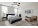 This bedroom features neutral walls, large windows, a ceiling fan, and an area rug at 1281 Arges River Dr, Fort Mill, SC 29715