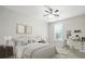 This bedroom has a ceiling fan, large windows, desk area, and neutral colored walls at 1281 Arges River Dr, Fort Mill, SC 29715