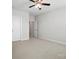This bedroom features neutral walls, a ceiling fan, carpet, and two entry doors at 1281 Arges River Dr, Fort Mill, SC 29715