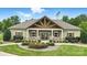 Community clubhouse featuring stone accents, a covered entryway, and landscaped grounds at 1281 Arges River Dr, Fort Mill, SC 29715