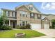 Charming two-story home with a well-maintained lawn, a cozy fire pit, and a two-car garage at 1281 Arges River Dr, Fort Mill, SC 29715