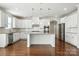A large kitchen with a center island, granite countertops, stainless steel appliances, and hardwood flooring at 1281 Arges River Dr, Fort Mill, SC 29715