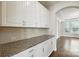 Long kitchen with granite countertops and white cabinets at 1281 Arges River Dr, Fort Mill, SC 29715
