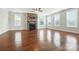 Spacious living room with hardwood floors, a stone fireplace, and large windows that provide ample natural light at 1281 Arges River Dr, Fort Mill, SC 29715