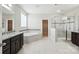 The main bathroom features an expansive vanity, separate glass shower, and garden tub, all with tile flooring at 1281 Arges River Dr, Fort Mill, SC 29715