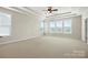 The main bedroom features neutral walls, carpeted floors, lots of natural light, and a tray ceiling with ceiling fan at 1281 Arges River Dr, Fort Mill, SC 29715