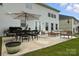 Back patio with outdoor seating, dining table, grill and umbrella, perfect for enjoying outdoor gatherings at 1281 Arges River Dr, Fort Mill, SC 29715