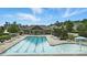 A view of the community pool on a sunny day with lounge chairs and neighborhood clubhouse at 1281 Arges River Dr, Fort Mill, SC 29715