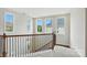 Bright staircase landing features carpeted steps, wood railing, and natural light from multiple windows at 1281 Arges River Dr, Fort Mill, SC 29715