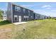 Large backyard featuring a well maintained lawn and patio area with new construction nearby at 1516 Respect Nw St, Concord, NC 28027