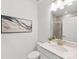 Stylish bathroom featuring a quartz countertop, decorative art, and a glass-enclosed shower at 1516 Respect Nw St, Concord, NC 28027