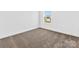 Bright bedroom featuring plush carpeting and a window offering outdoor views at 1516 Respect Nw St, Concord, NC 28027