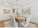 Bright dining room with a wooden table, chandelier, and decorative artwork on the walls at 1516 Respect Nw St, Concord, NC 28027