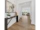 Open entryway with wood floors leading to a spacious living area, enhanced by modern decor at 1516 Respect Nw St, Concord, NC 28027