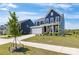 Beautiful two-story home featuring manicured landscaping and a bright red front door at 1516 Respect Nw St, Concord, NC 28027