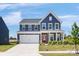 Charming two-story home with a well-maintained lawn, a two-car garage, and a welcoming red front door at 1516 Respect Nw St, Concord, NC 28027