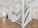 Inviting foyer with hardwood floors, white wainscoting, and staircase at 1516 Respect Nw St, Concord, NC 28027