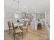Open kitchen and dining area with island, stainless steel appliances, and hardwood flooring at 1516 Respect Nw St, Concord, NC 28027