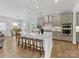 Kitchen boasts a central island with seating, stainless steel appliances, and modern gray cabinetry at 1516 Respect Nw St, Concord, NC 28027