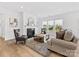Comfortable living room featuring a fireplace, hardwood flooring, and plenty of natural light at 1516 Respect Nw St, Concord, NC 28027