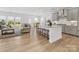 Open-concept space with a kitchen island, dining area, and living room, perfect for entertaining at 1516 Respect Nw St, Concord, NC 28027