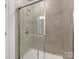 Modern bathroom shower with gray tiled walls and clear glass enclosure at 1516 Respect Nw St, Concord, NC 28027