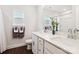 Bright bathroom featuring double sinks, white cabinets, and dark wood flooring at 154 Cotton Field Dr, Statesville, NC 28677