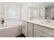 Bright bathroom featuring a tub, double sinks, and wood floors at 154 Cotton Field Dr, Statesville, NC 28677