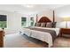 Bright bedroom features a king bed, neutral carpet, and two windows at 154 Cotton Field Dr, Statesville, NC 28677