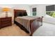 Comfortable bedroom features a sleigh bed, neutral carpet, and two windows at 154 Cotton Field Dr, Statesville, NC 28677