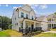 Elegant two-story home with stone accents, a welcoming front porch, and well-maintained landscaping at 154 Cotton Field Dr, Statesville, NC 28677