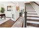 Inviting foyer featuring hardwood floors, elegant staircase, decorative rug, and classic wainscoting at 154 Cotton Field Dr, Statesville, NC 28677