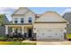 Charming two-story home with white siding, stone accents, and a two-car garage in a well-manicured neighborhood at 154 Cotton Field Dr, Statesville, NC 28677