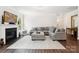Comfortable living room with a fireplace, gray sectional sofa, and neutral decor, perfect for relaxation at 154 Cotton Field Dr, Statesville, NC 28677
