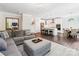 Open-concept living space with a modern kitchen, gray sectional sofa, and stylish decor at 154 Cotton Field Dr, Statesville, NC 28677