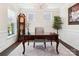 Cozy home office featuring a decorative chandelier, antique clock, hardwood floors, and ample natural light at 154 Cotton Field Dr, Statesville, NC 28677