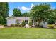 Well-maintained backyard with lush green grass, mature trees, and a cozy patio area; ideal for outdoor enjoyment at 172 Wildwood Loop, Statesville, NC 28625