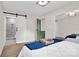 Bedroom showcases a sliding barn door leading to the bathroom, with views of a comfortable bed at 172 Wildwood Loop, Statesville, NC 28625