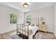 Bright bedroom with two large windows, neutral colors, and a decorative metal bed frame at 172 Wildwood Loop, Statesville, NC 28625