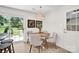 Cozy dining area with a round wooden table, seating for four, and sliding door access to the backyard at 172 Wildwood Loop, Statesville, NC 28625