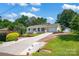 Inviting home showcasing a long driveway, manicured lawn, and charming exterior features at 172 Wildwood Loop, Statesville, NC 28625