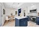 Modern kitchen with an island, white cabinets, and stainless steel appliances; perfect for cooking and entertaining at 172 Wildwood Loop, Statesville, NC 28625