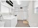 Spacious laundry room with a white washer, dryer, and ample shelving for storage at 172 Wildwood Loop, Statesville, NC 28625