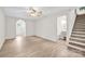 Open living area with hardwood floors, stairs, and an arched doorway leading to the foyer at 172 Wildwood Loop, Statesville, NC 28625