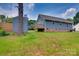 Expansive backyard featuring a wooden deck, convenient storage shed, and lush green lawn at 1916 Bess Town Rd, Bessemer City, NC 28016