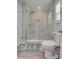 Bright bathroom featuring frameless glass shower and decorative rug at 1916 Bess Town Rd, Bessemer City, NC 28016
